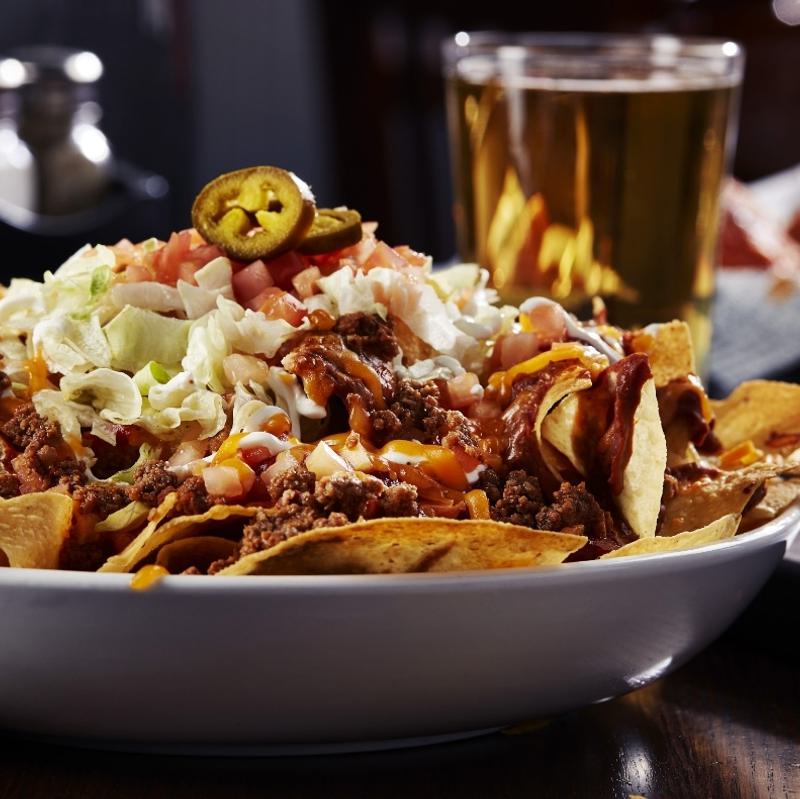 Nachos from sports bar and grill Big Whiskey's local happy hours menu.